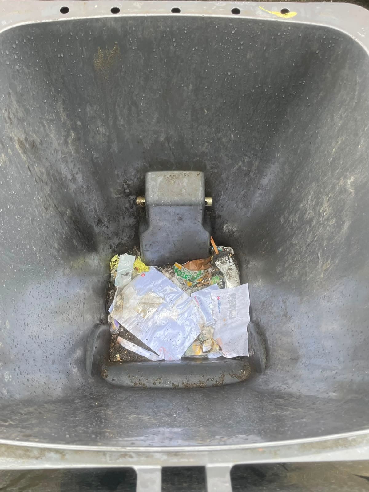 Excessively dirty black garbage can interior