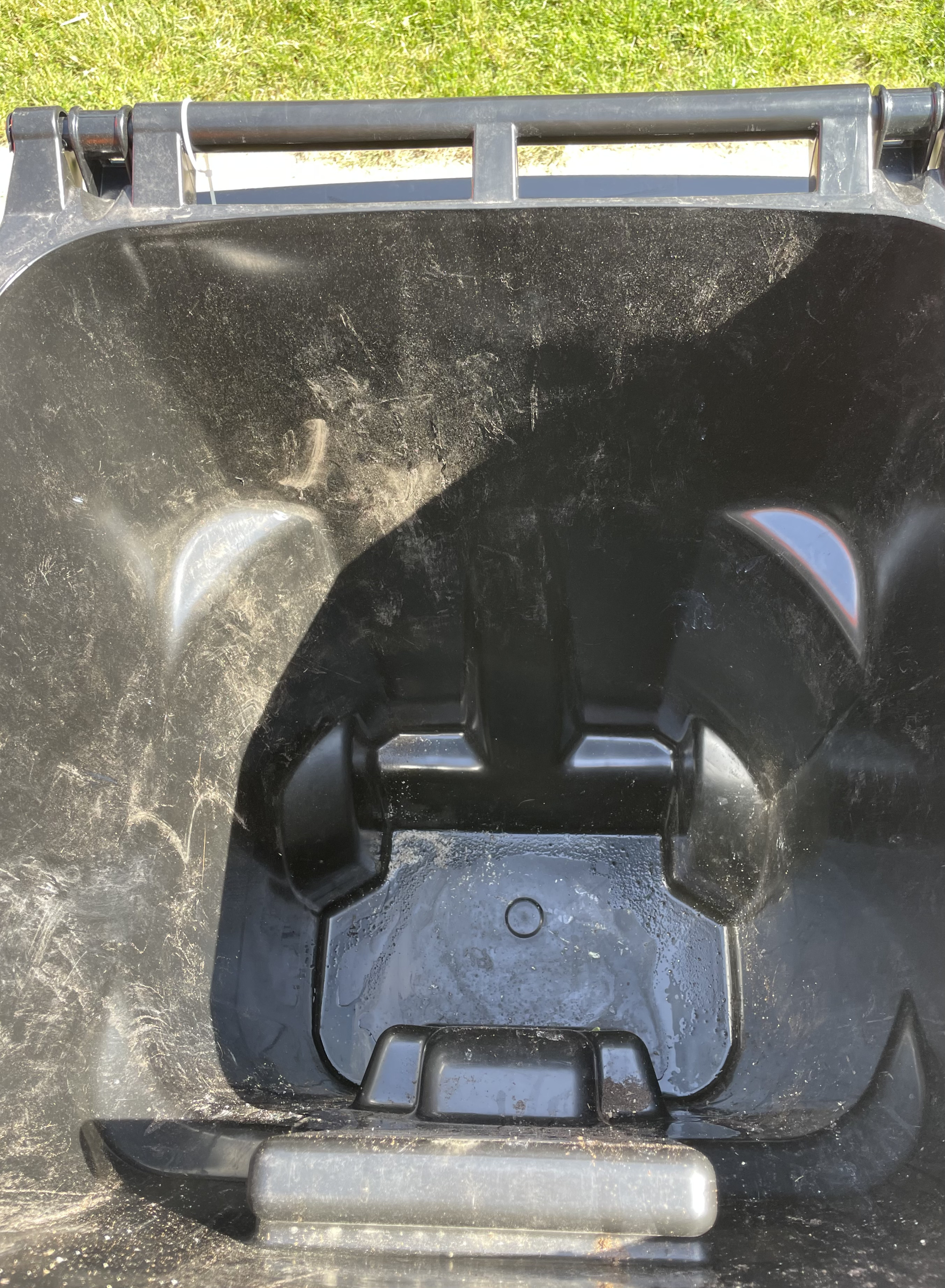 Clean black garbage can after regular monthly service